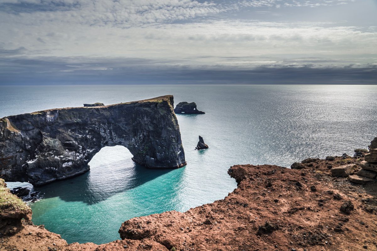Dyrholaey arch by the sea in south iceland