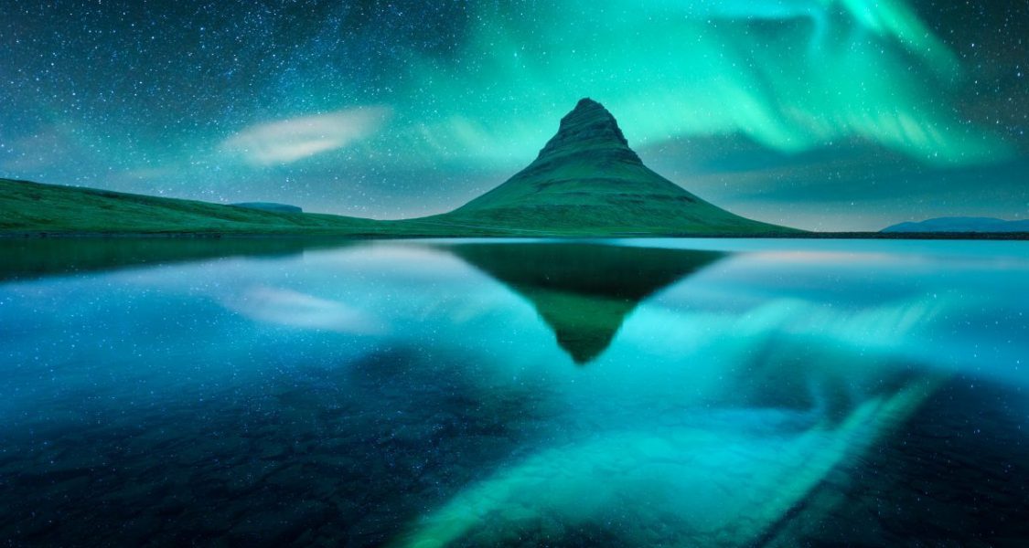 kirkjufell mountain under the northern lights in iceland